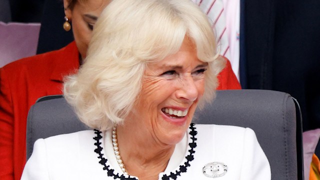 Camilla, Duchess of Cornwall looks on as Prince Louis of Cambridge sits on his grandfather Prince Charles, Prince of Wales's lap as they attend the Platinum Pageant on The Mall on June 5, 2022 in London, England. 