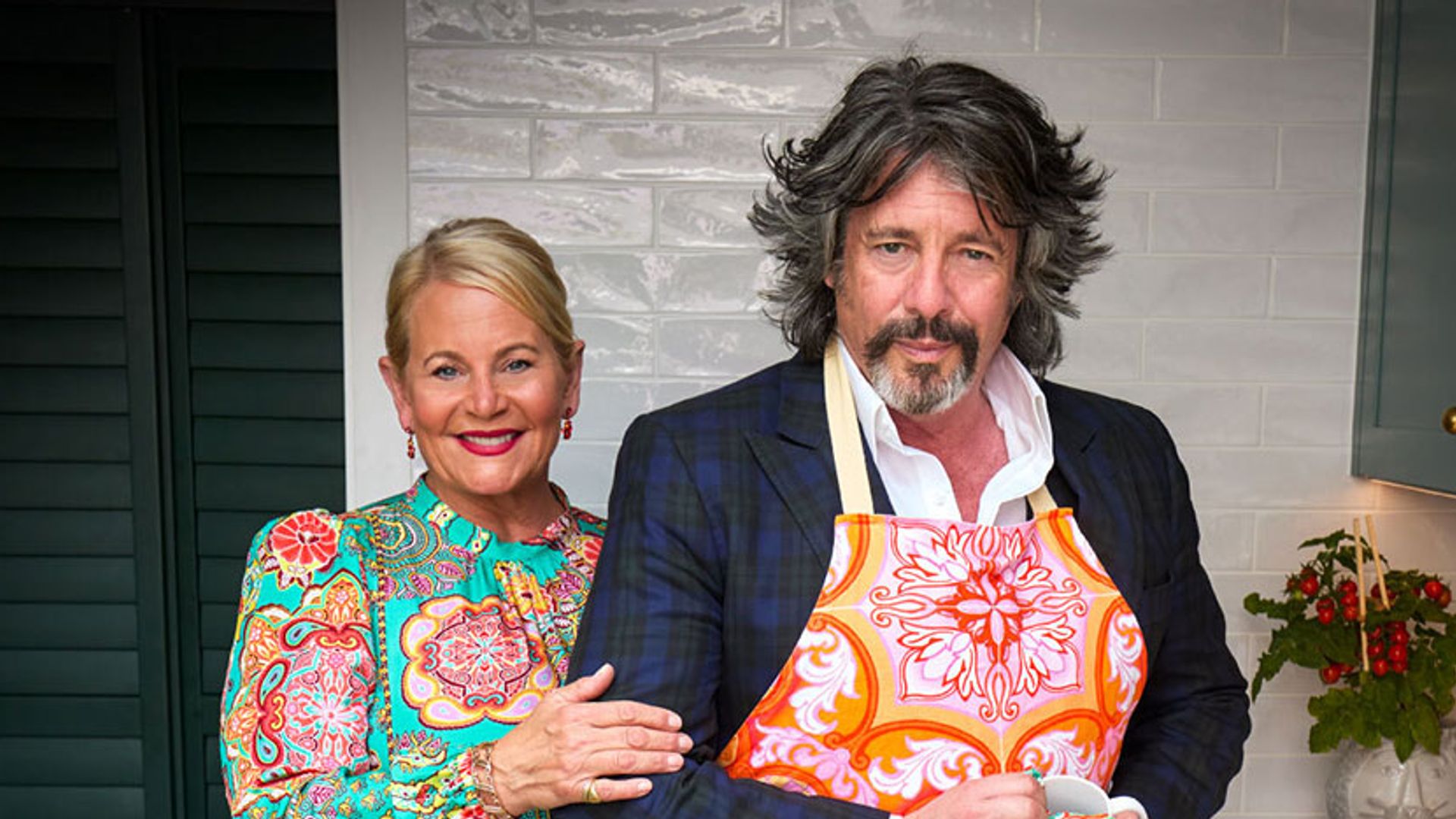 Laurence Llewelyn-Bowen posing in Cotswolds kitchen with wife Jackie 