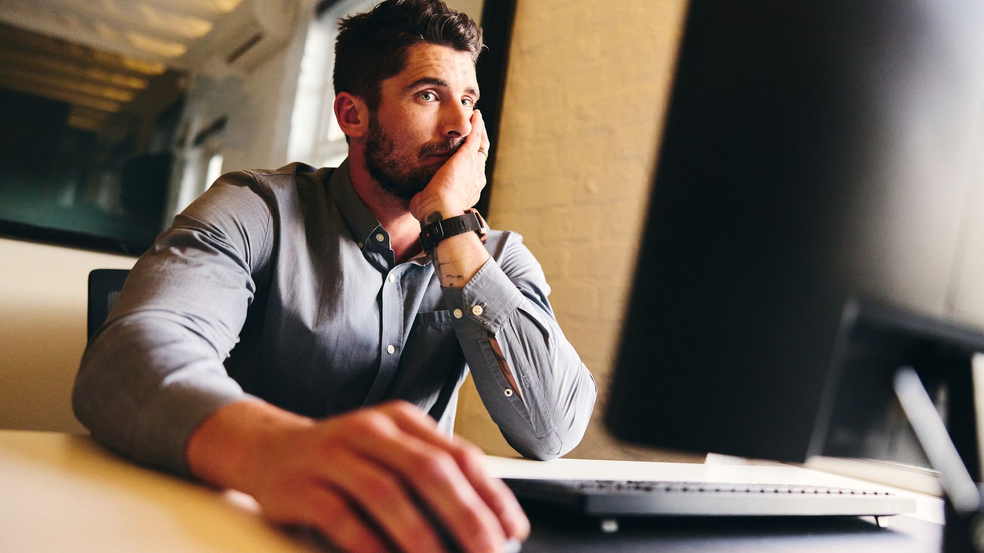bored man working at computer