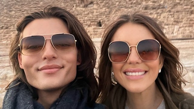 mother posing with son in front of pyramid