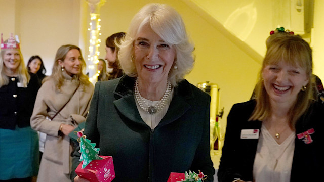 Queen Camilla holding two Christmas boxes