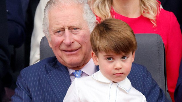 Prince Louis of Cambridge sits on his grandfather King Charles