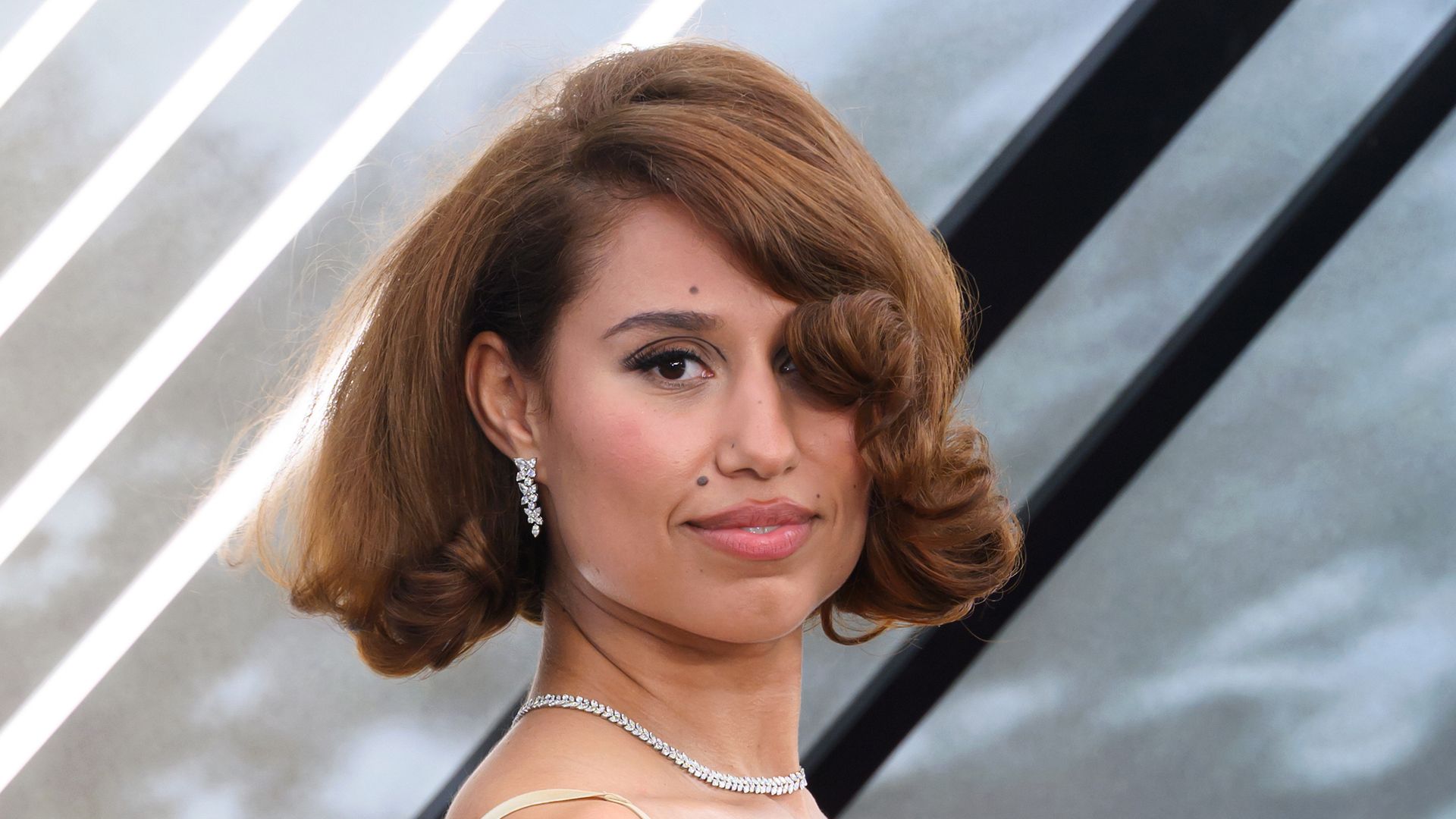 Raye in a green floral dress