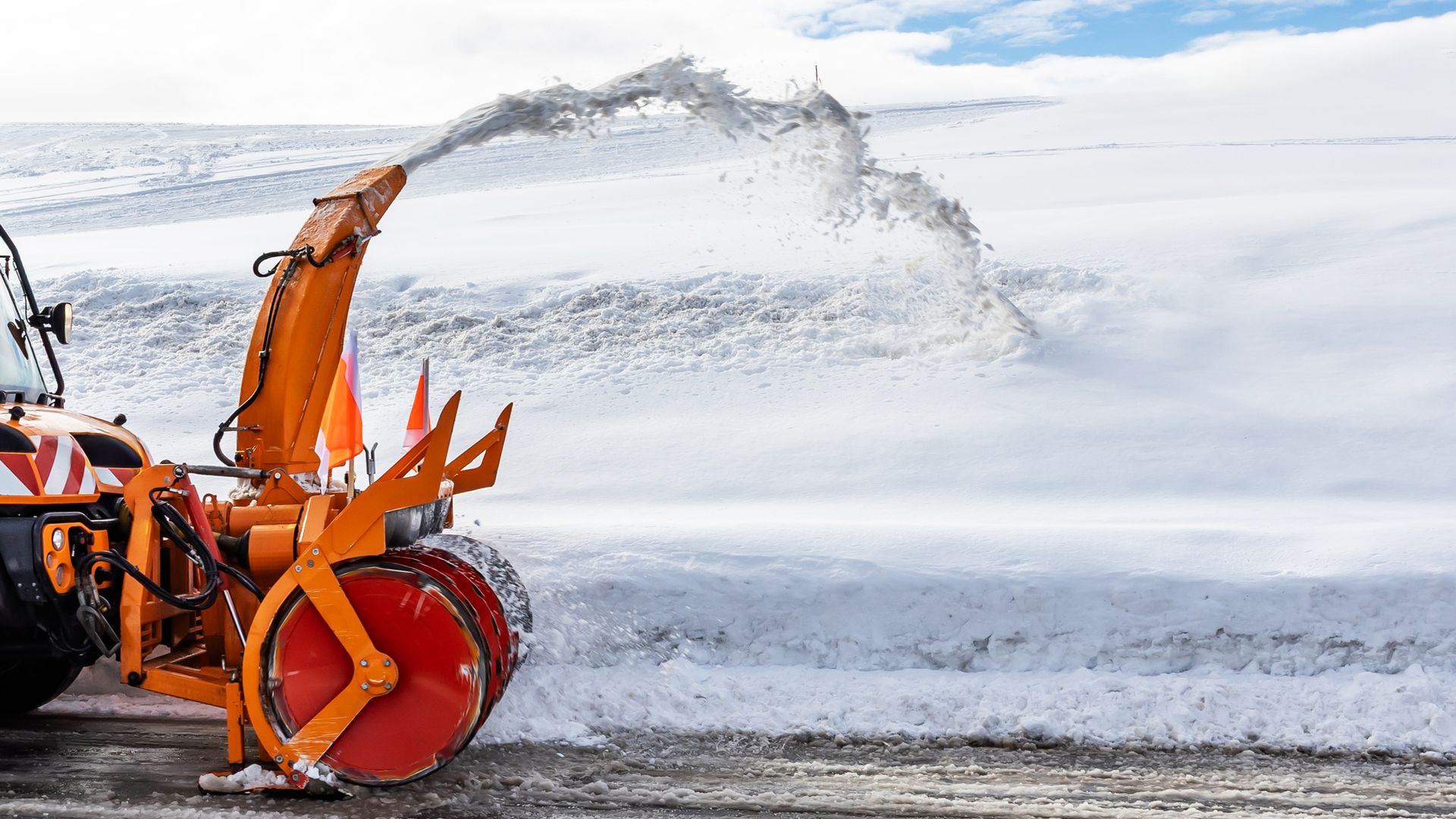 Snow plow clears the road of snow