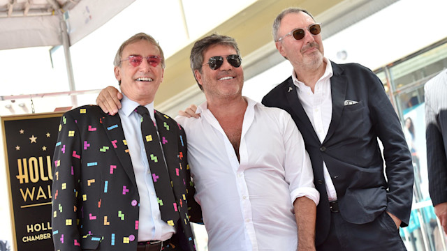 Simon Cowell standing with brothers Tony and Nicholas