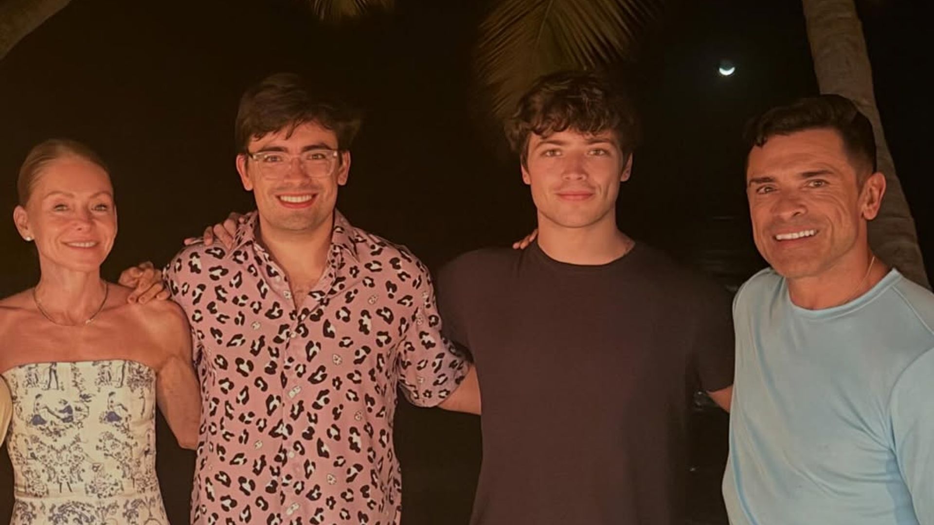 Kelly Ripa and Mark Consuelos' sons Michael and Joaquin towered over their parents as they posed on the beach