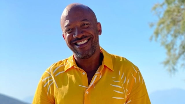 Craig Rowe smiles in front of beach for A Place in the Sun