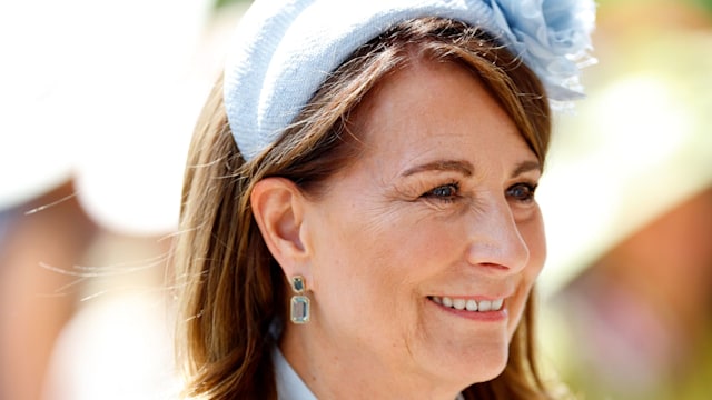 Carole Middleton side on in blue dress and hat