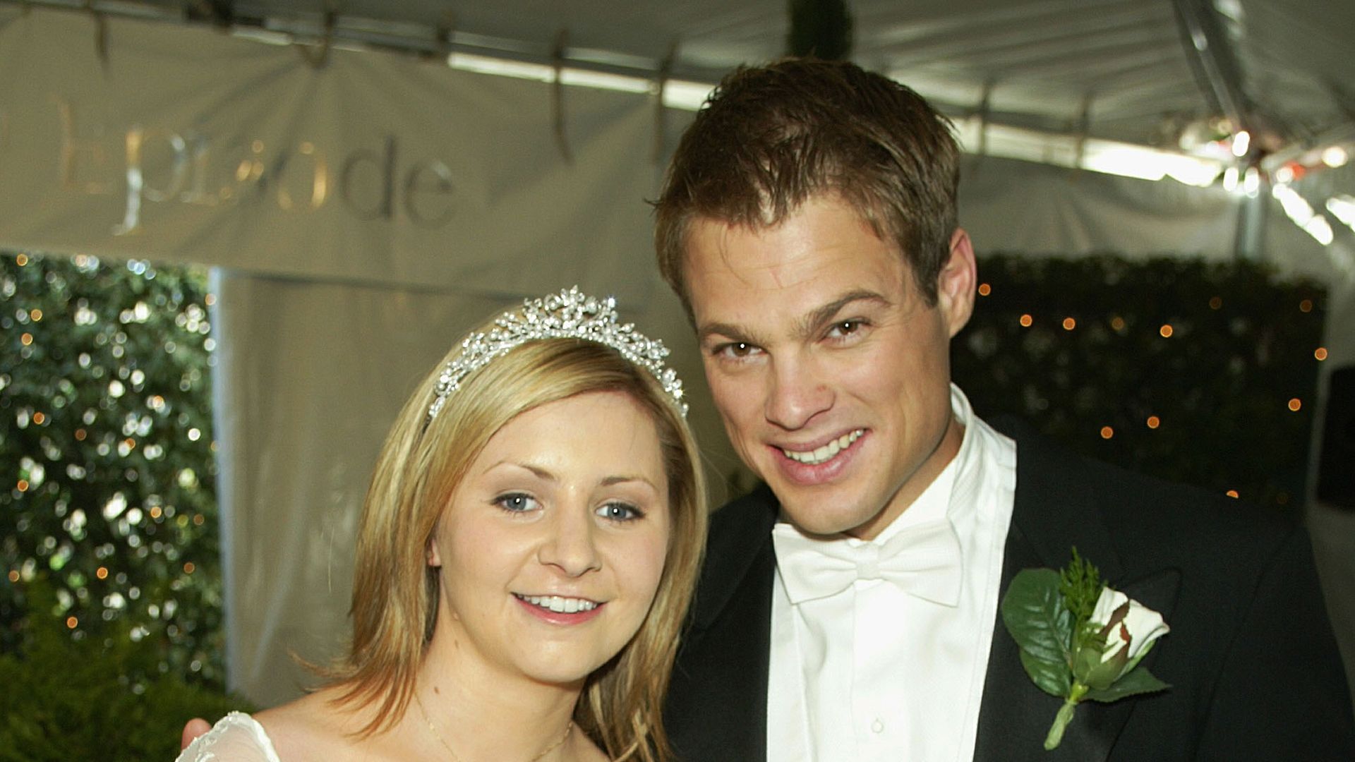 Actress Beverley Mitchell (L) and actor George Stults, who marry in a future episode, pose at a reception to celebrate 150 episodes of The WB's "7th Heaven" on February 20, 2003 in Los Angeles, California.