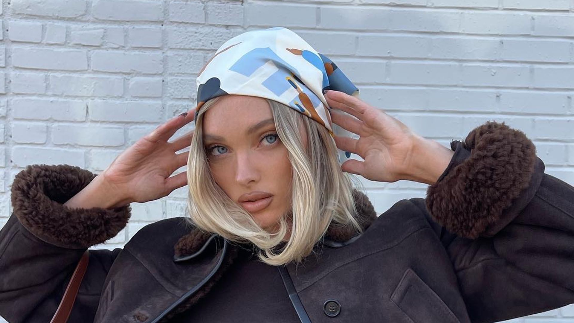 Elsa Hosk styles a brown jacket with jeans and a headscarf