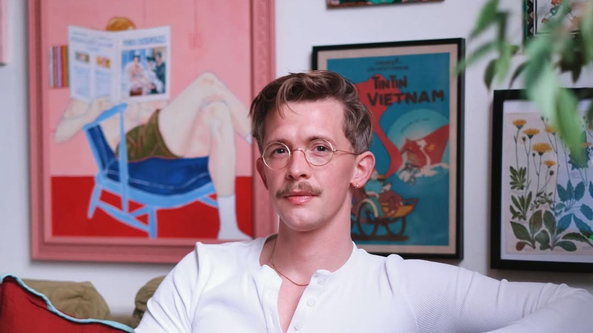 man with glasses sat on sofa 