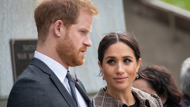 Prince Harry and Meghan Markle looking serious at an engagement