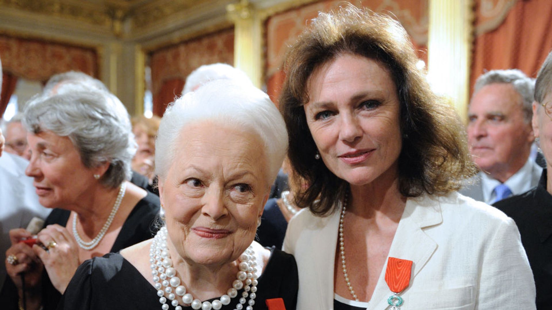 Jacqueline Bisset and Olivia de Havilland pose after they were awarded chevalier of the Legion of Honour