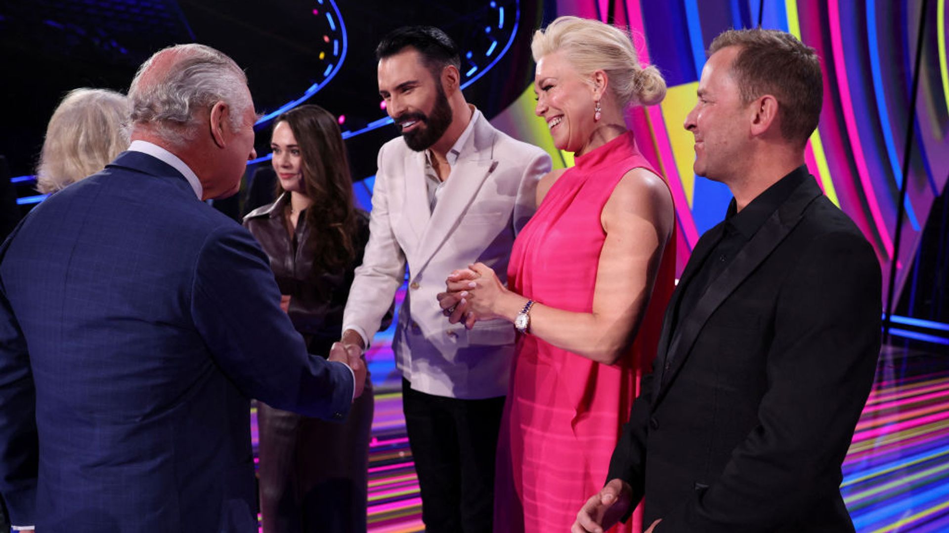Rylan Clark shakes King Charles' hand during a meeting on stage at the Eurovision 2023 arena in Liverpool