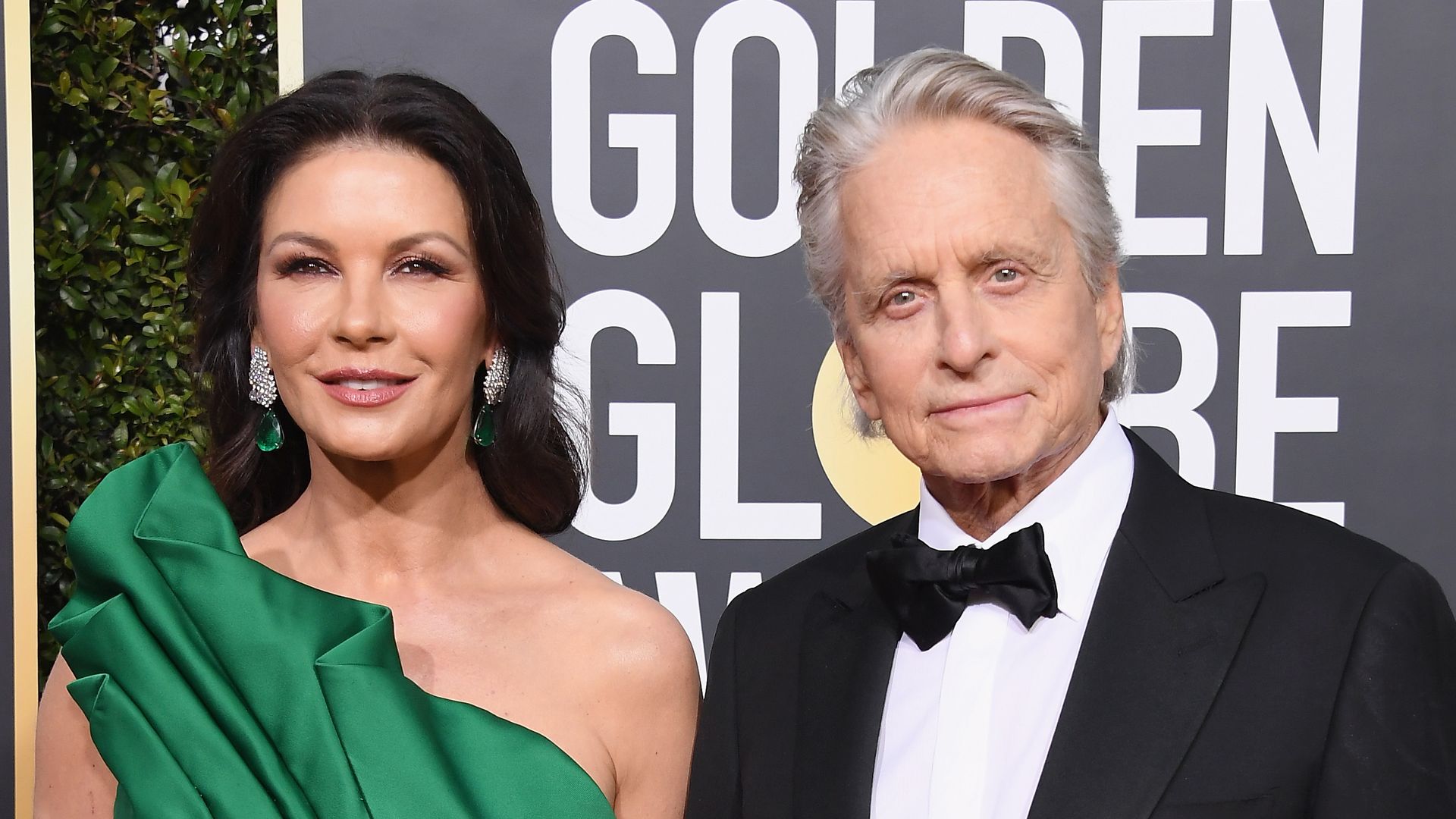 photo of catherine zeta jones in green dress and michael douglas in tux at golden globes 2019