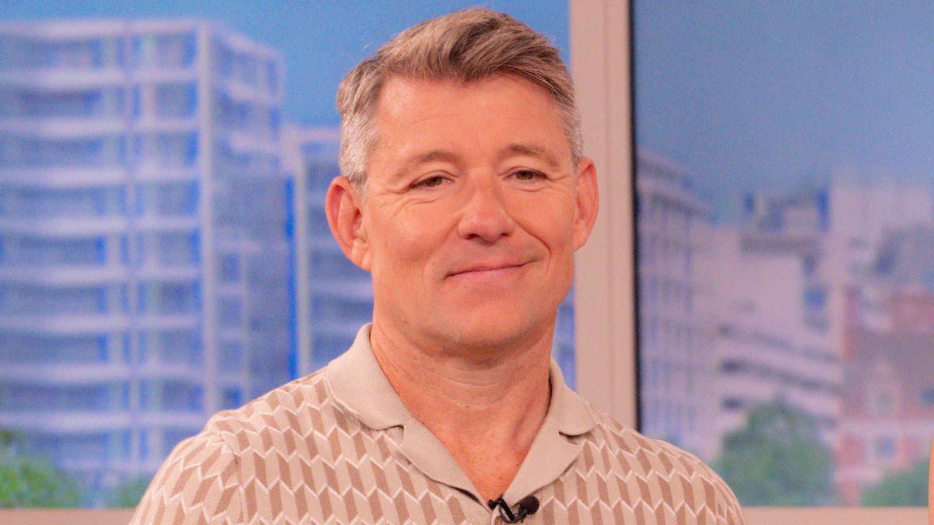 Ben Shephard smirking in a cream top