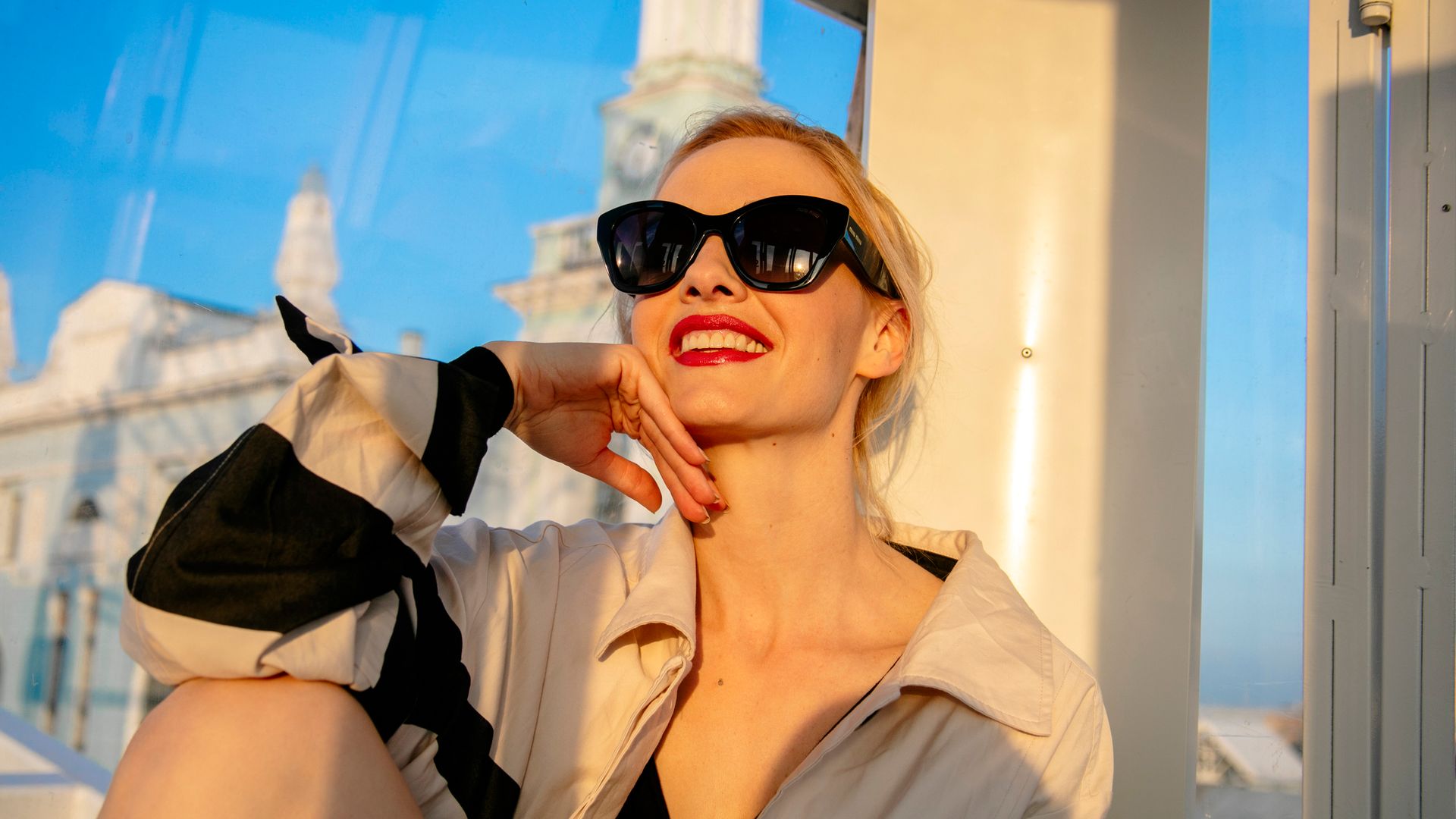 Female wears, black , retro style sunglasses
