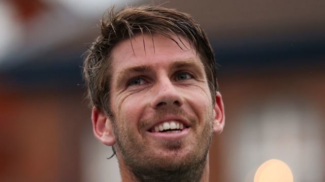 cameron norrie smiling in blue zig zag top 
