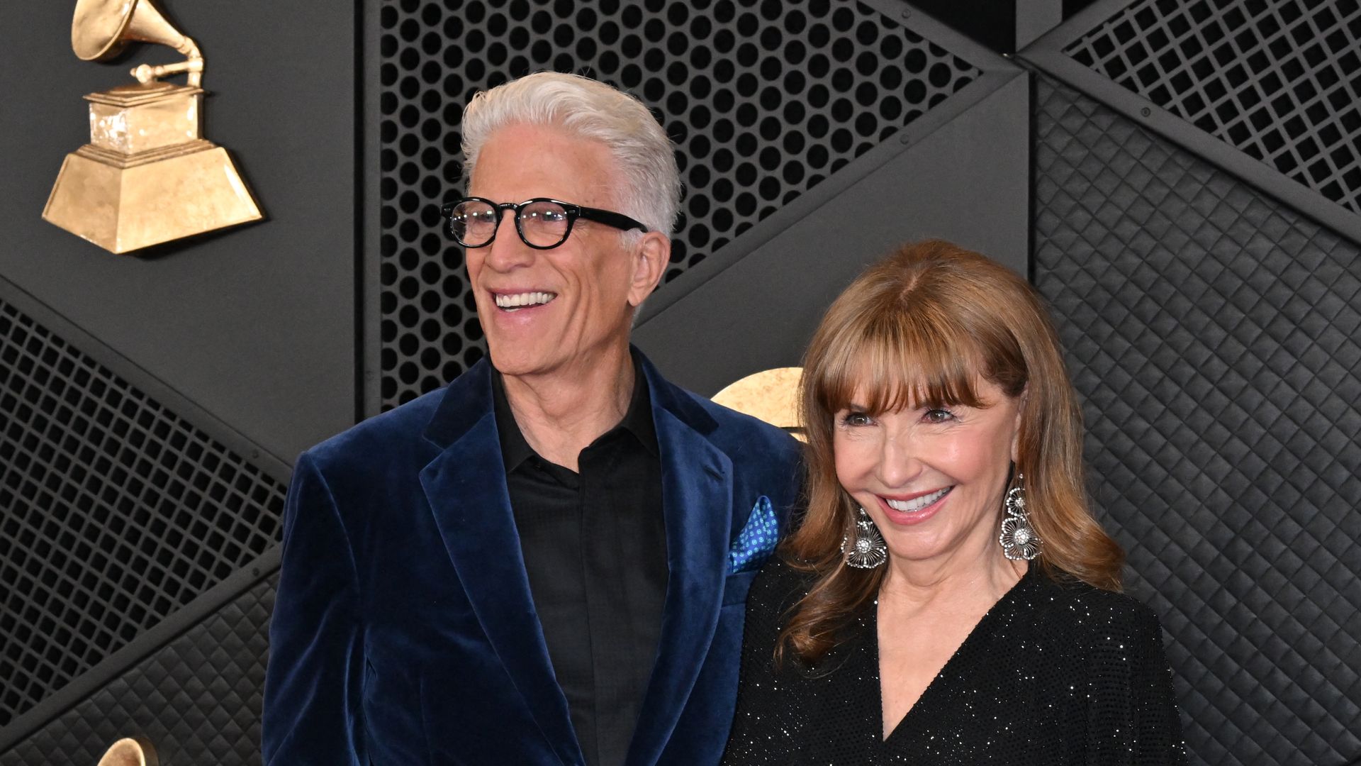 Ted Danson in blue velvet blazer and his wife Mary Steenburgen in black dress arrive at the 66th Annual Grammy Awards in 2024