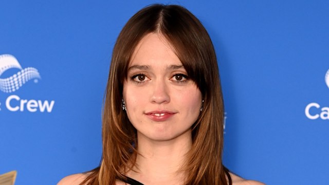 young woman in black dress posing for photo