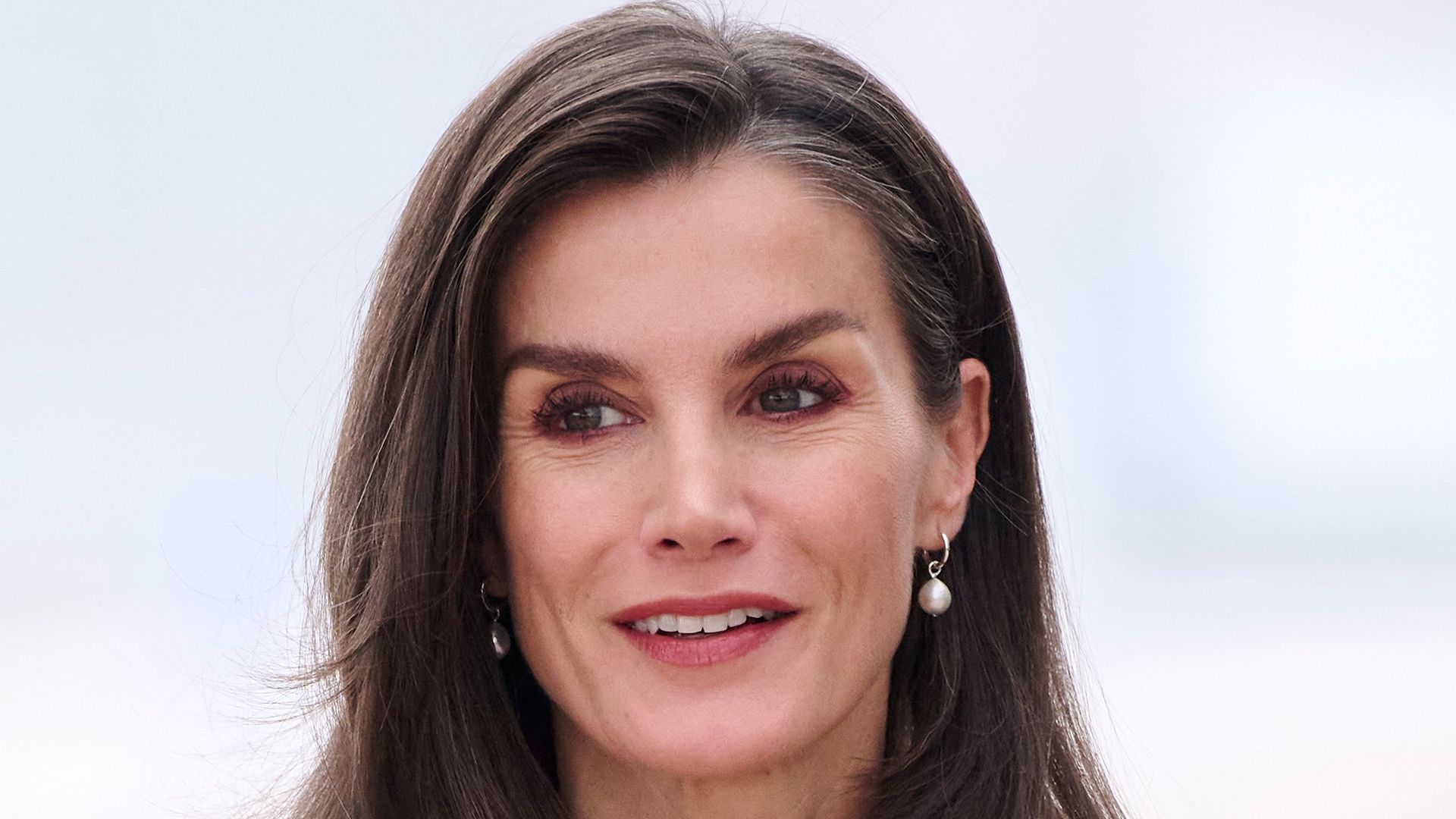 Queen Letizia oozes style in waist-cinching festive suit alongside King Felipe