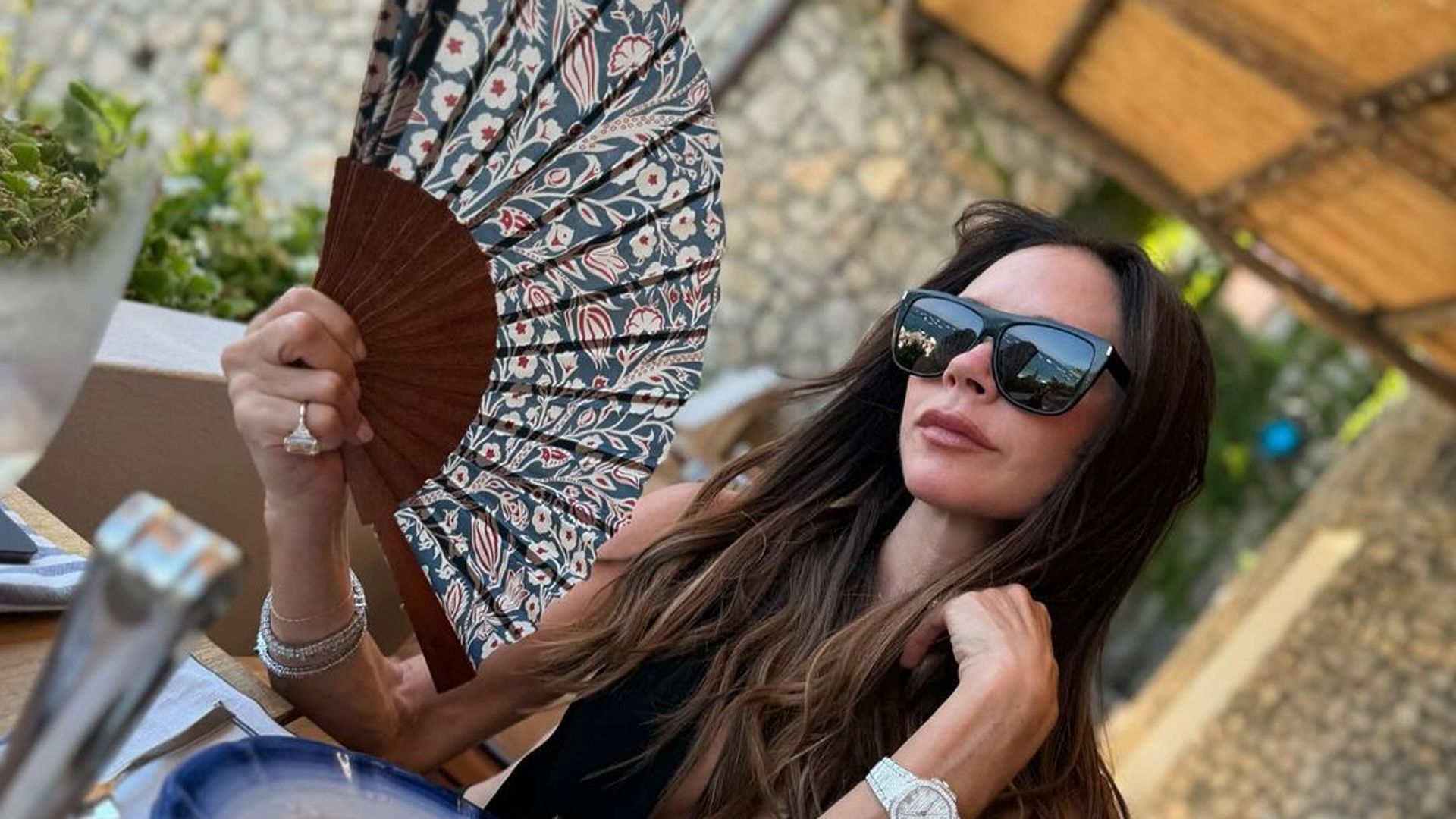 Victoria Beckham’s muscles are next level in plunging beach dress as husband David reacts