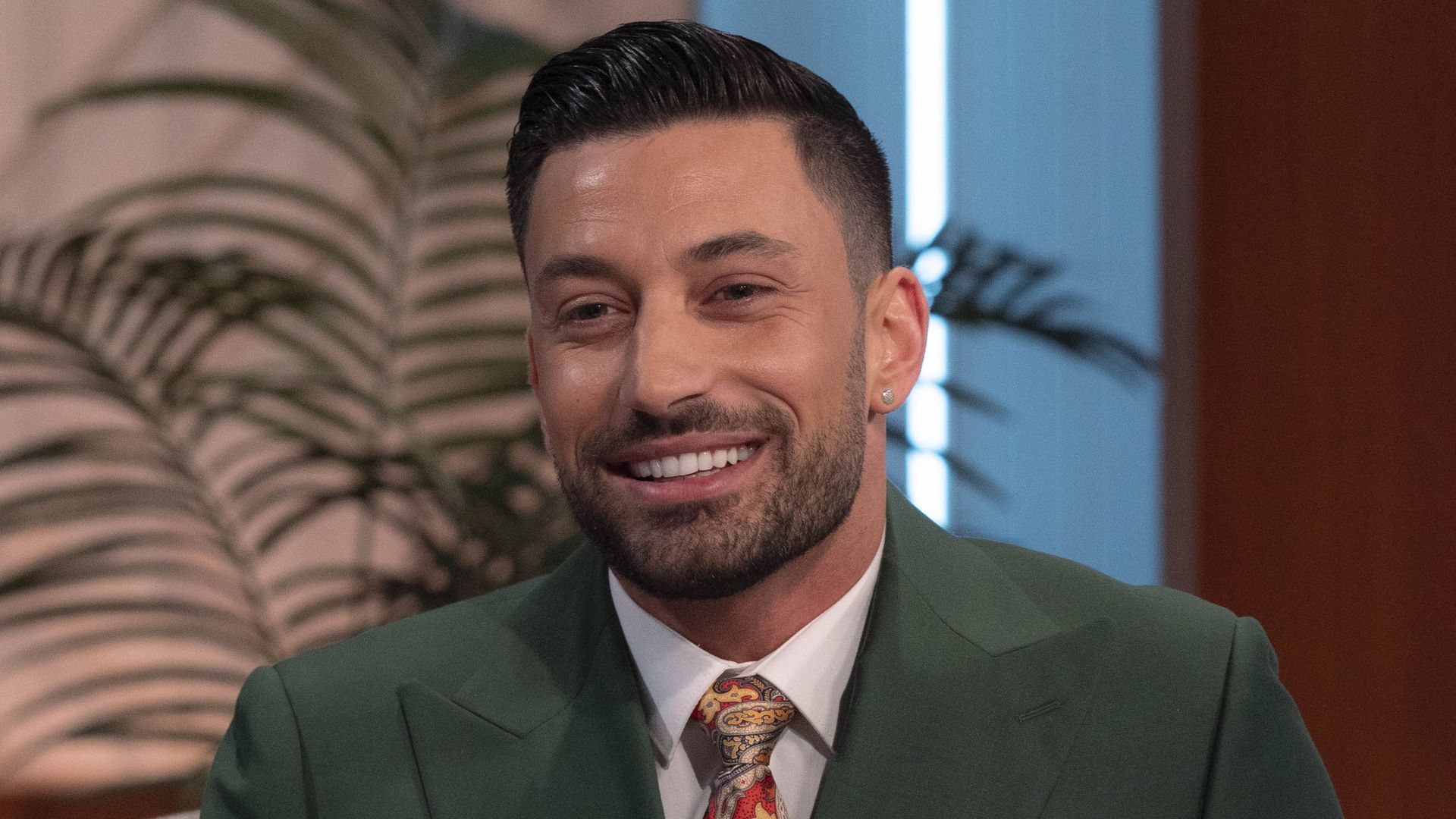 Giovanni Pernice smiling in a green suit