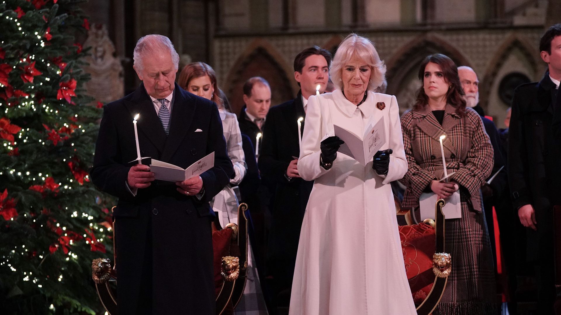 Charles and Camilla holding candles and singing at Kate's Christmas concert