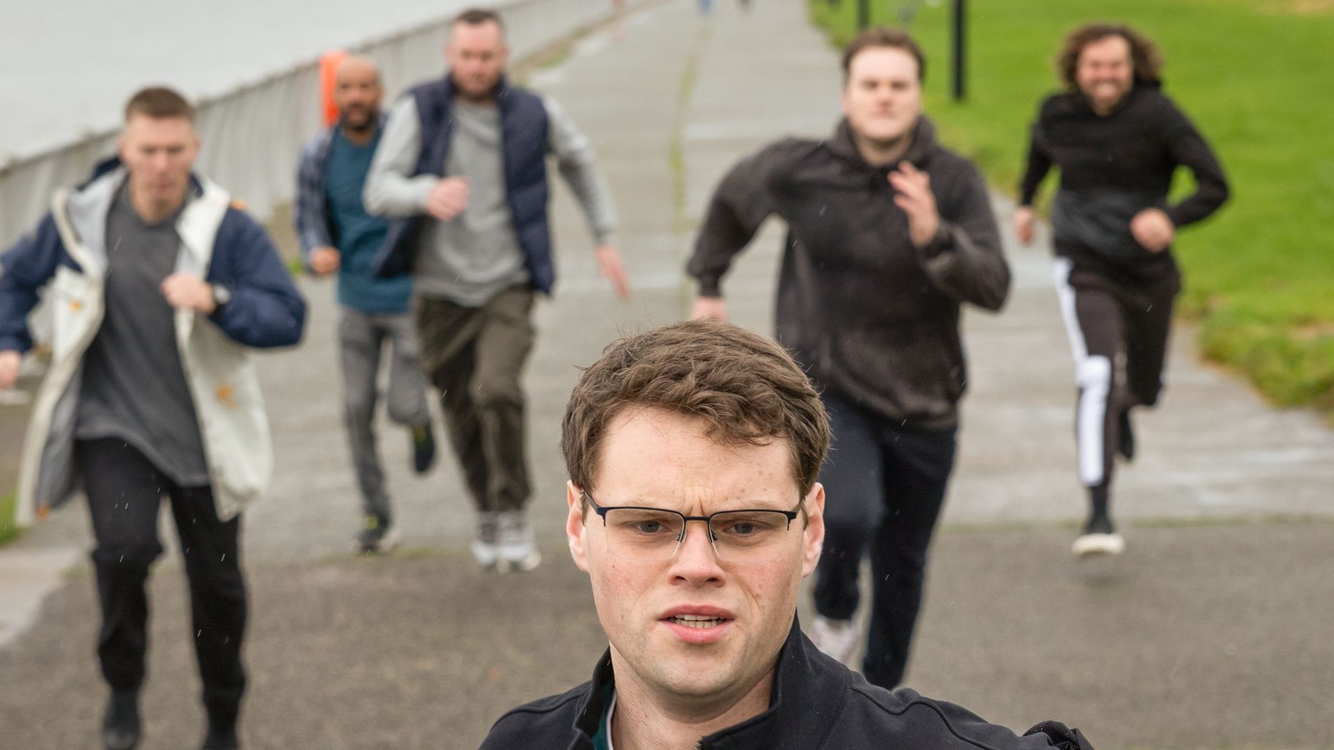 man running away from group of men