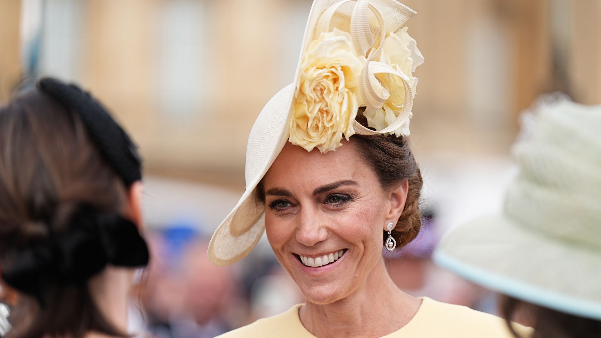 Kate wearing yellow hat and dress at garden party