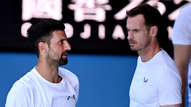 Novak Djokovic talks with coach Andy Murray