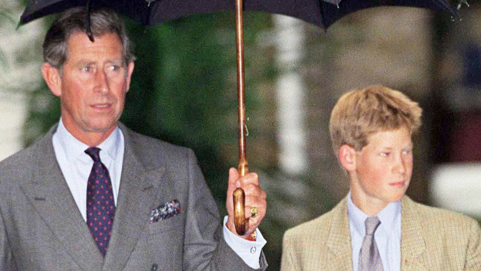 Prince Harry under an umbrella at Eton College with King Charles