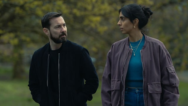 Man and woman walking in park