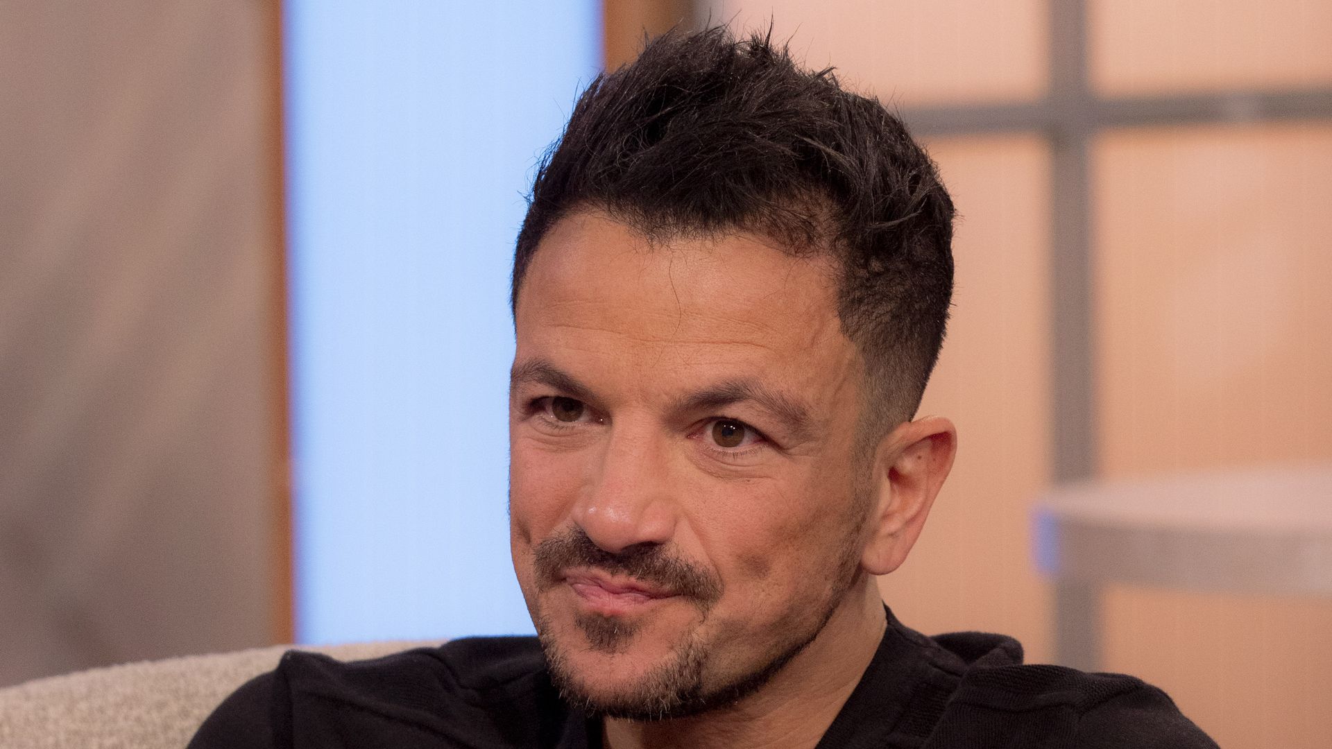 Peter Andre looking sad in a black jumper