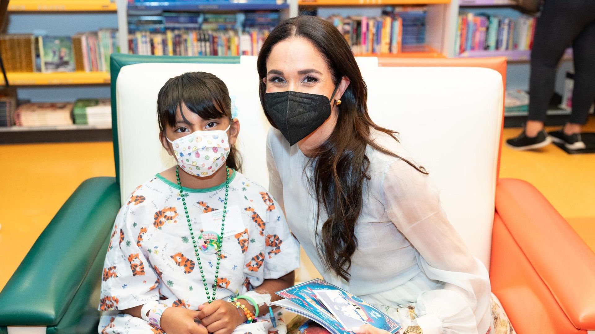 Meghan Markle posing for photograph with young patient