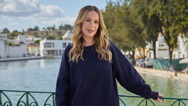 kate in front of lake in navy tracksuit