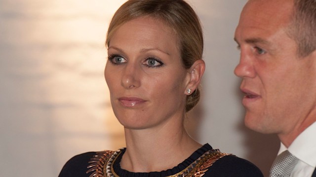 Zara Phillips in a black dress with her hair up alongside Mike Tindall 