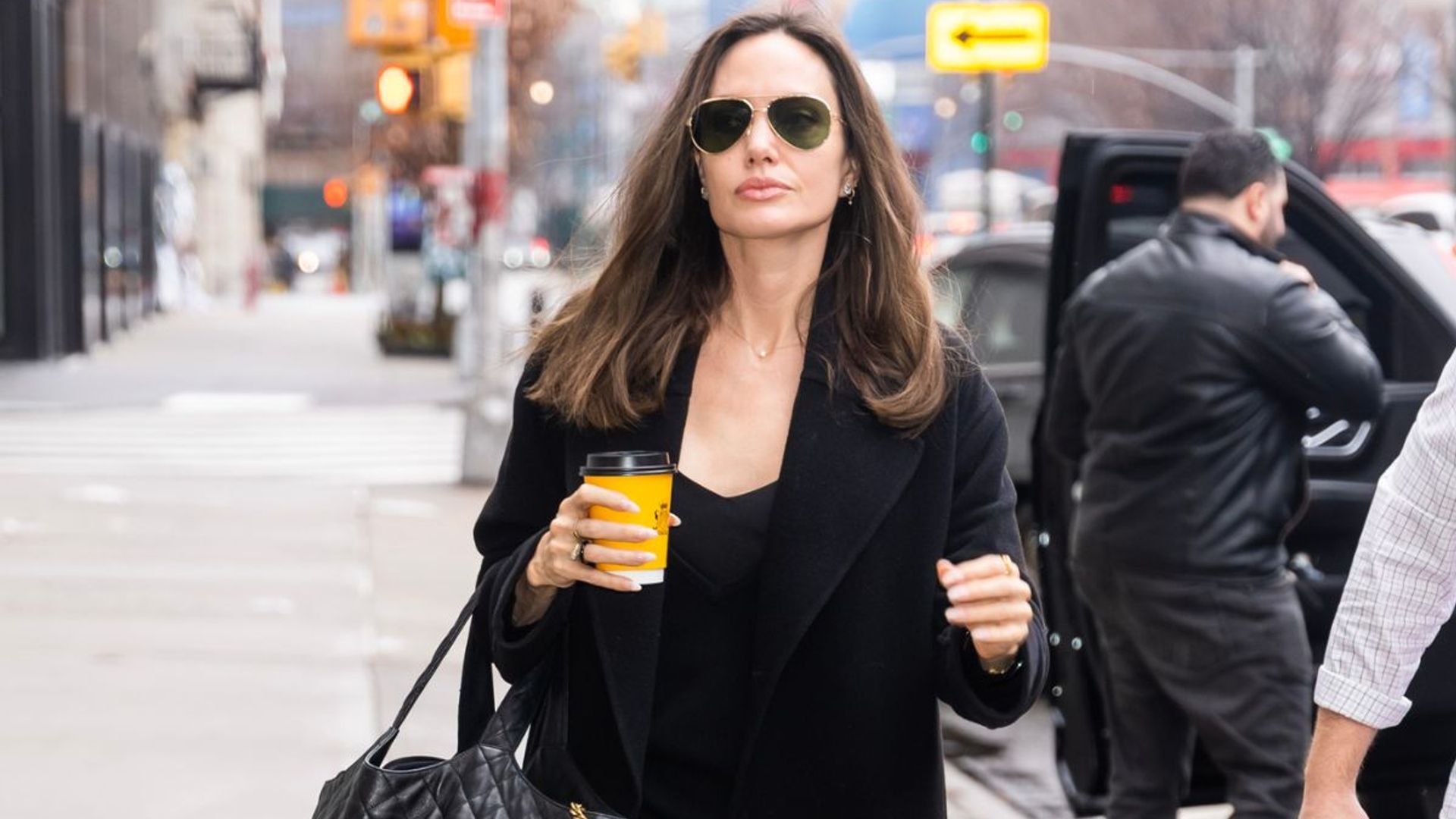 Angelina Jolie just perfected the coffee run in a 90s throwback slip dress  - see photos