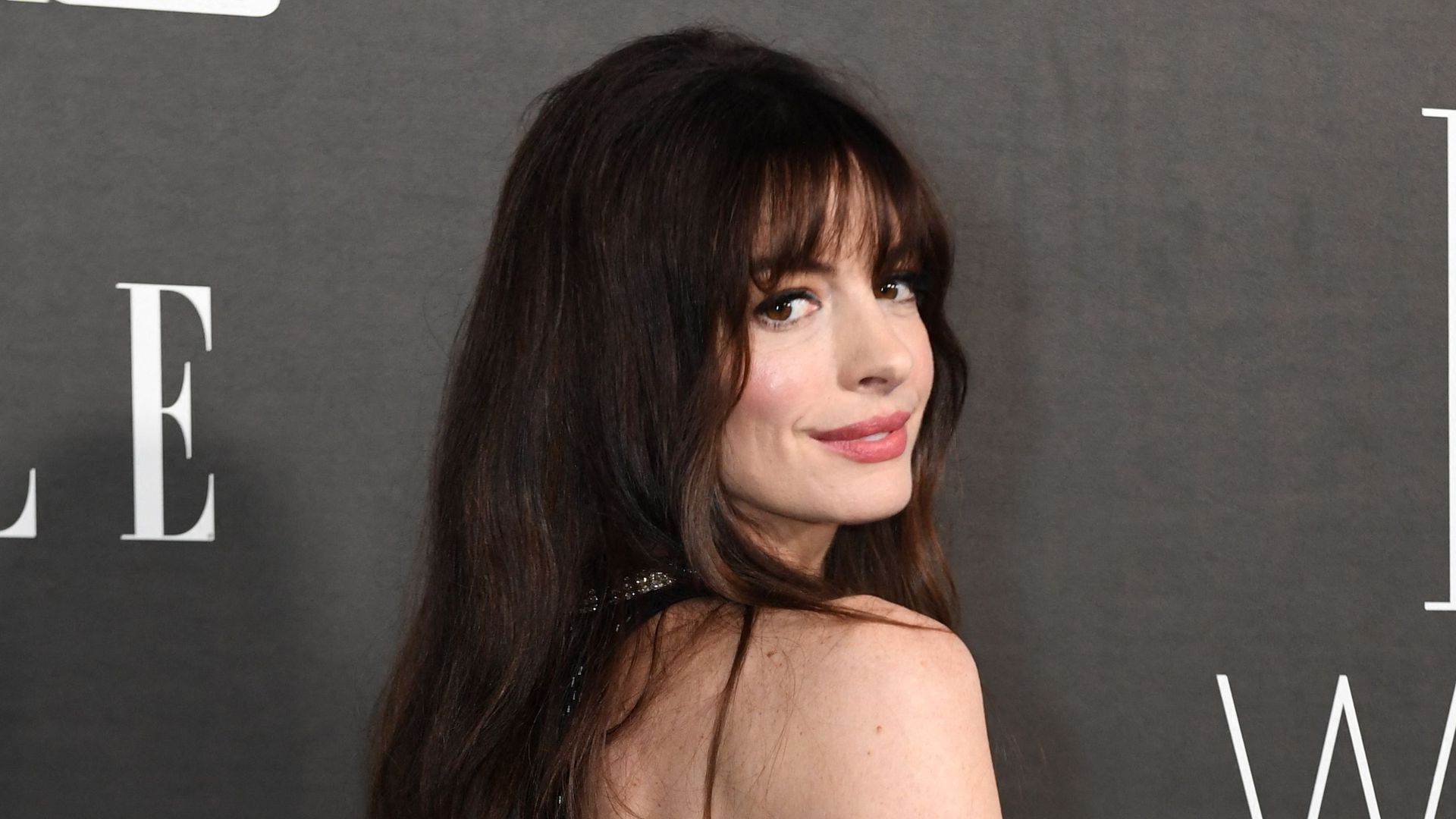 US actress Anne Hathaway attends the 29th Annual ELLE Women In Hollywood Celebration at The Getty Center in Los Angeles wearing a sparkly low back dress