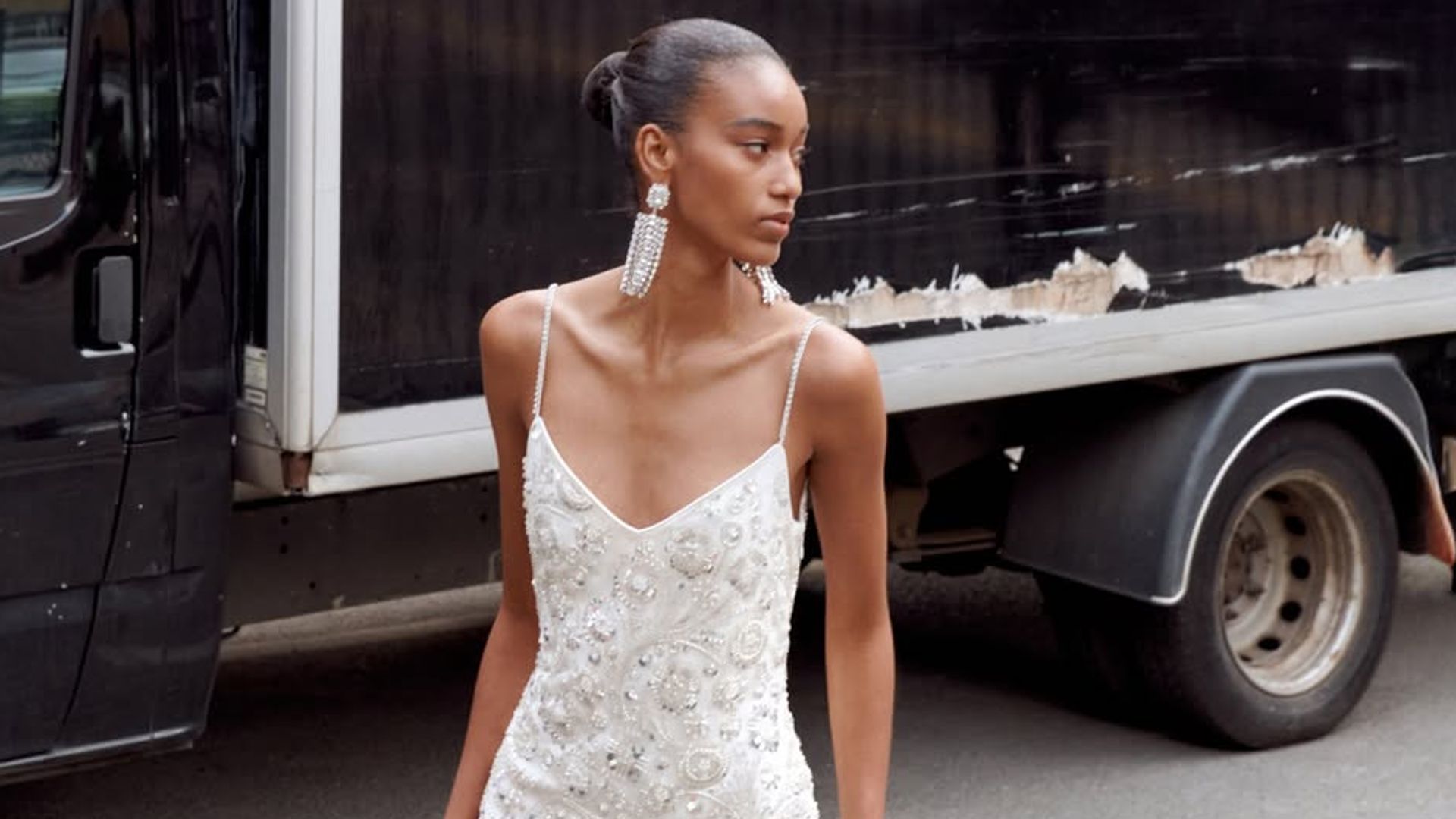 model in white bridal gown in the street
