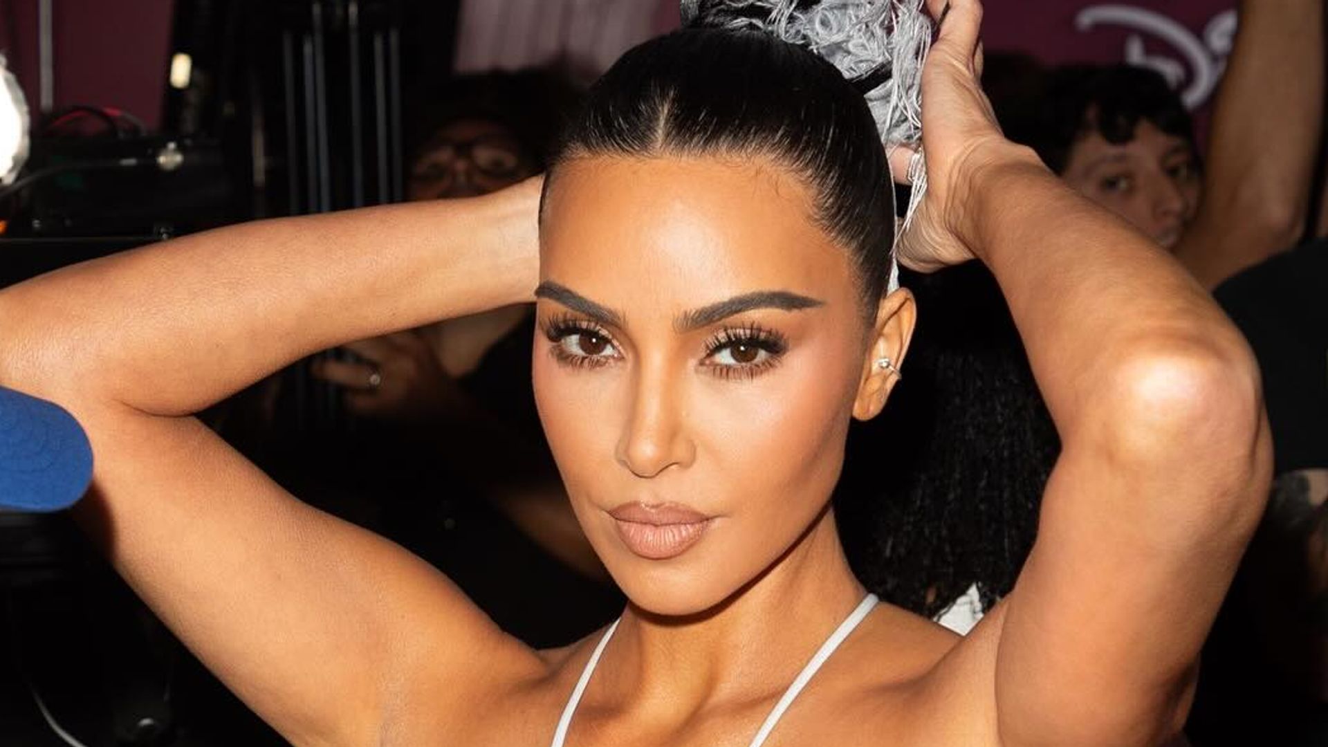 Kim Kardashian poses in a white dress on her Instagram