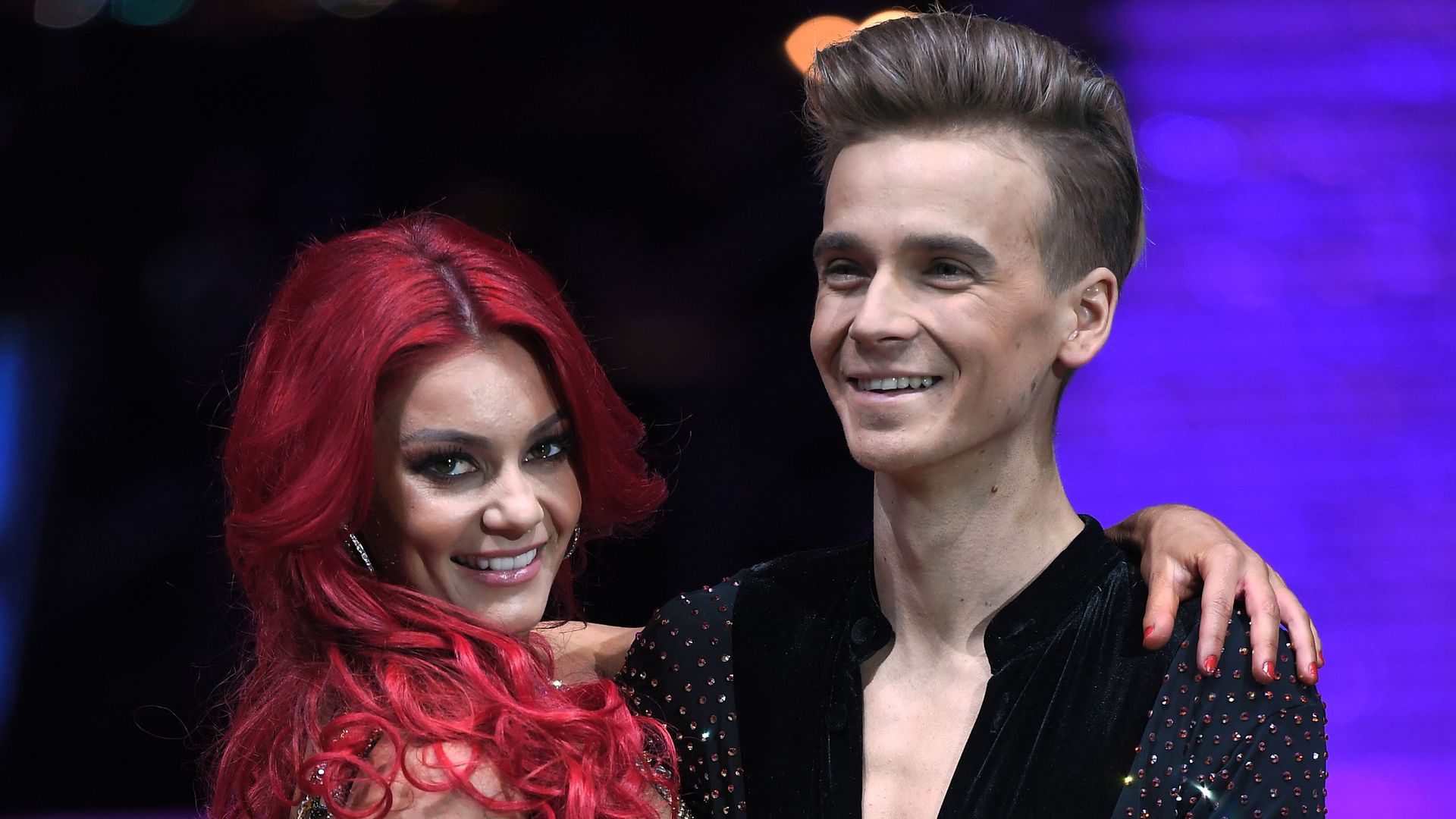 Dianne Buswell with her leg being held by Joe Sugg