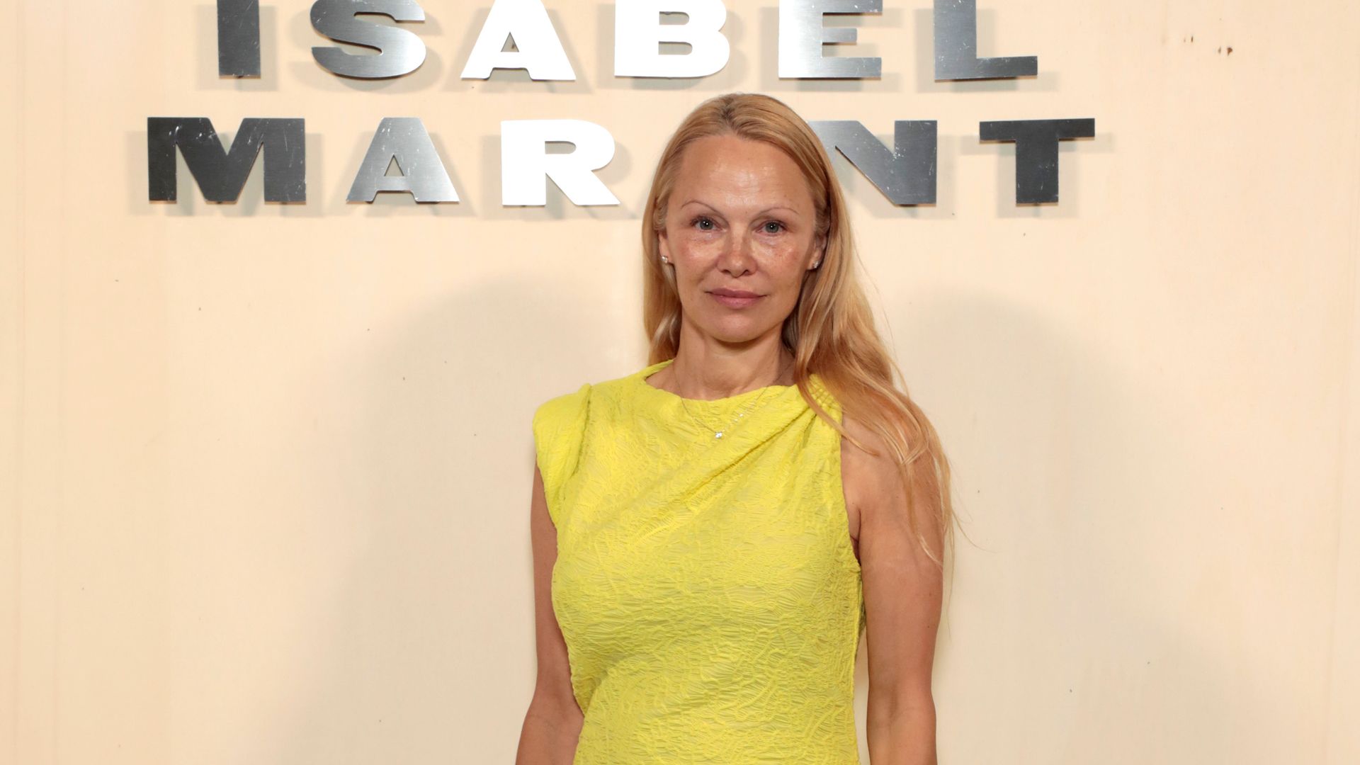 Pamela Anderson, 56, turns heads in Paris in form-fitting yellow dress