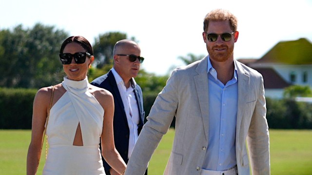 The couple held hands as the arrived at the polo