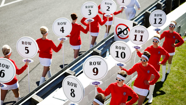 Women dressed in vintage England football kit parade on the race track during the Goodwood Revival at Goodwood on September 11, 2016 in Chichester, England.  