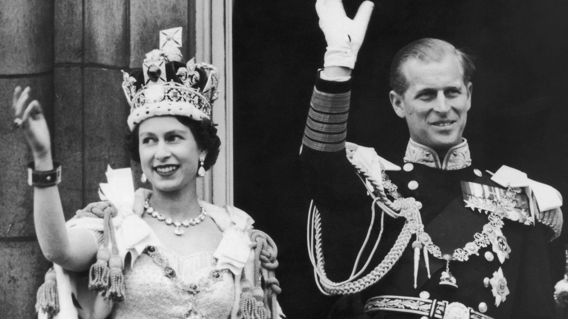 Queen Elizabeth II and the Duke of Edinburgh wave at the crowds from the balcony at Buckingham Palace after Elizabeth's coronation