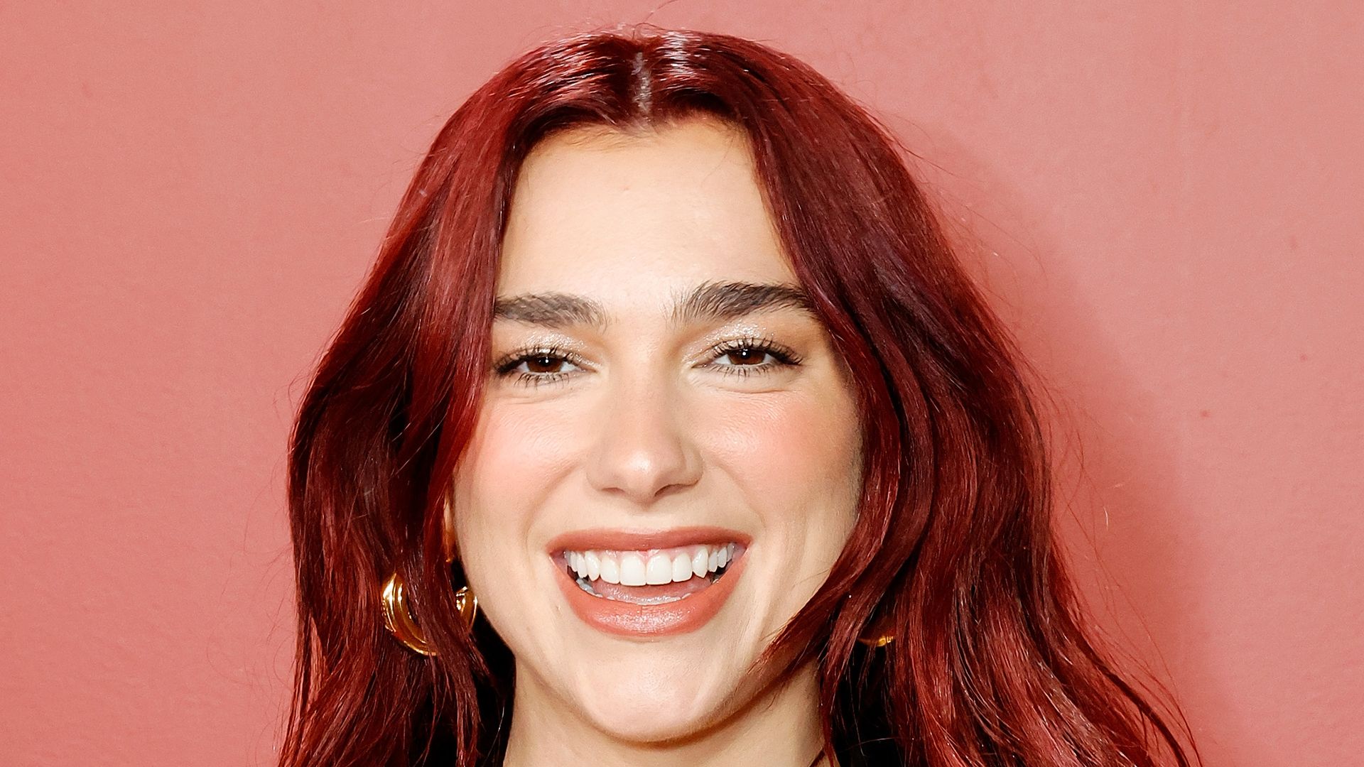 Dua Lipa is a scarlet mermaid in skintight satin dress after hair