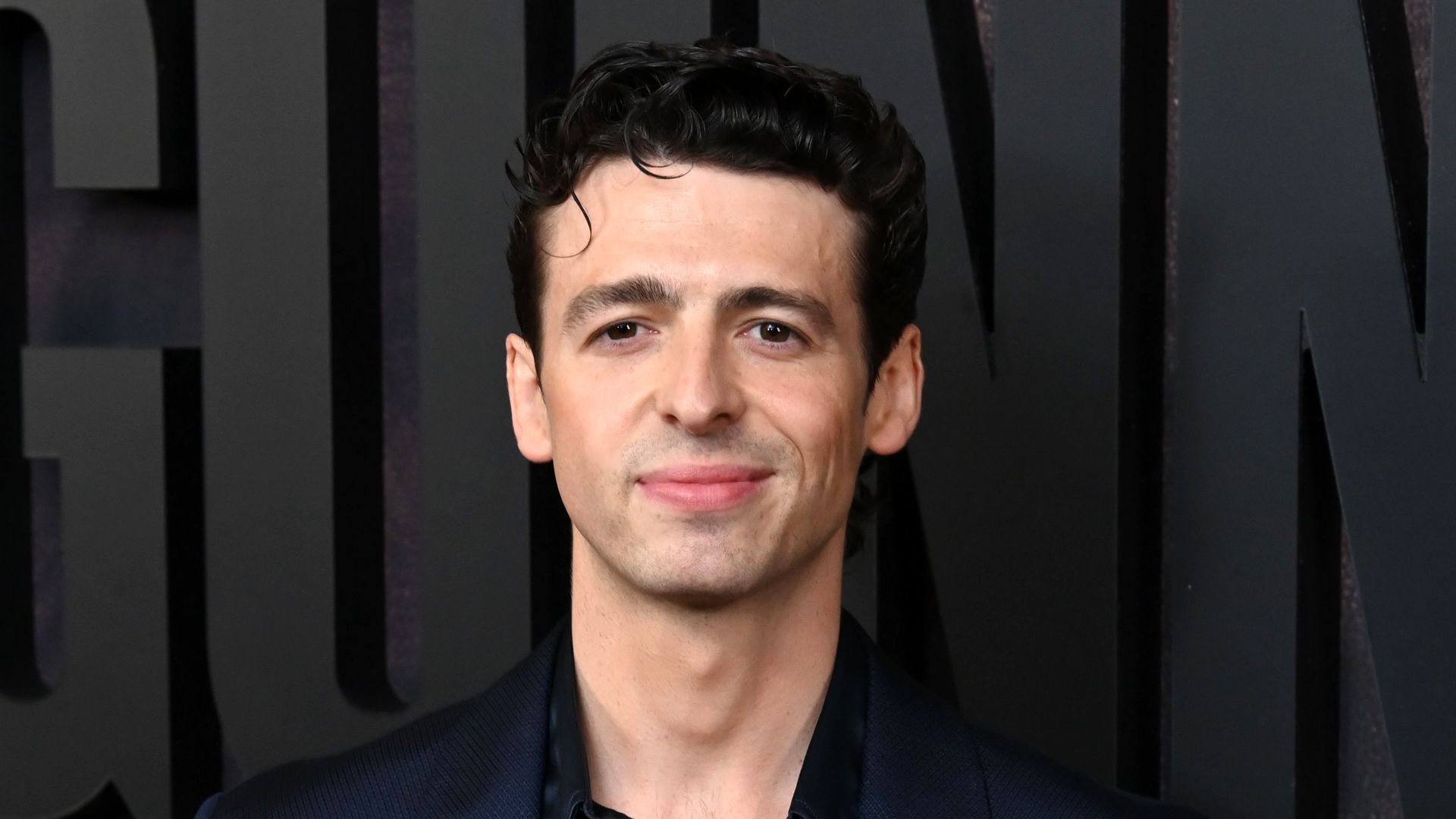 man in suit posing for photo