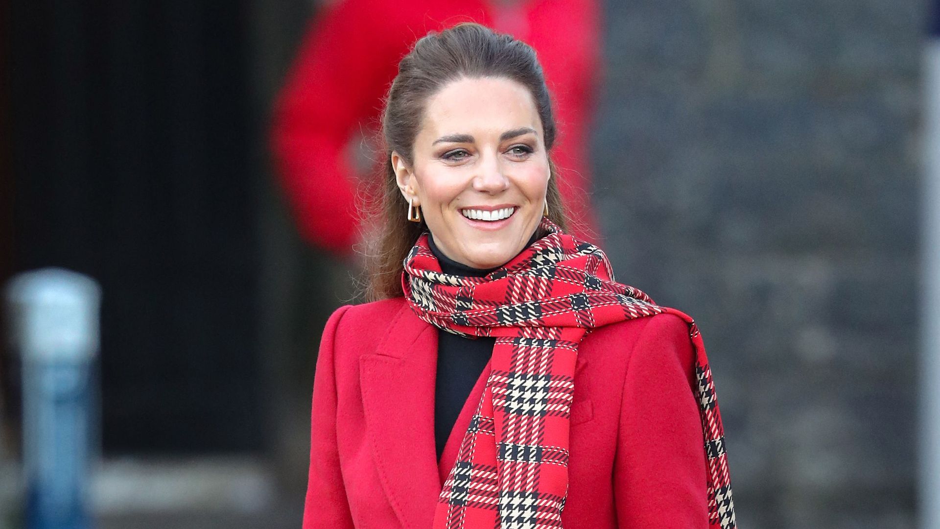 Kate Middleton wearing a red tartan scarf 