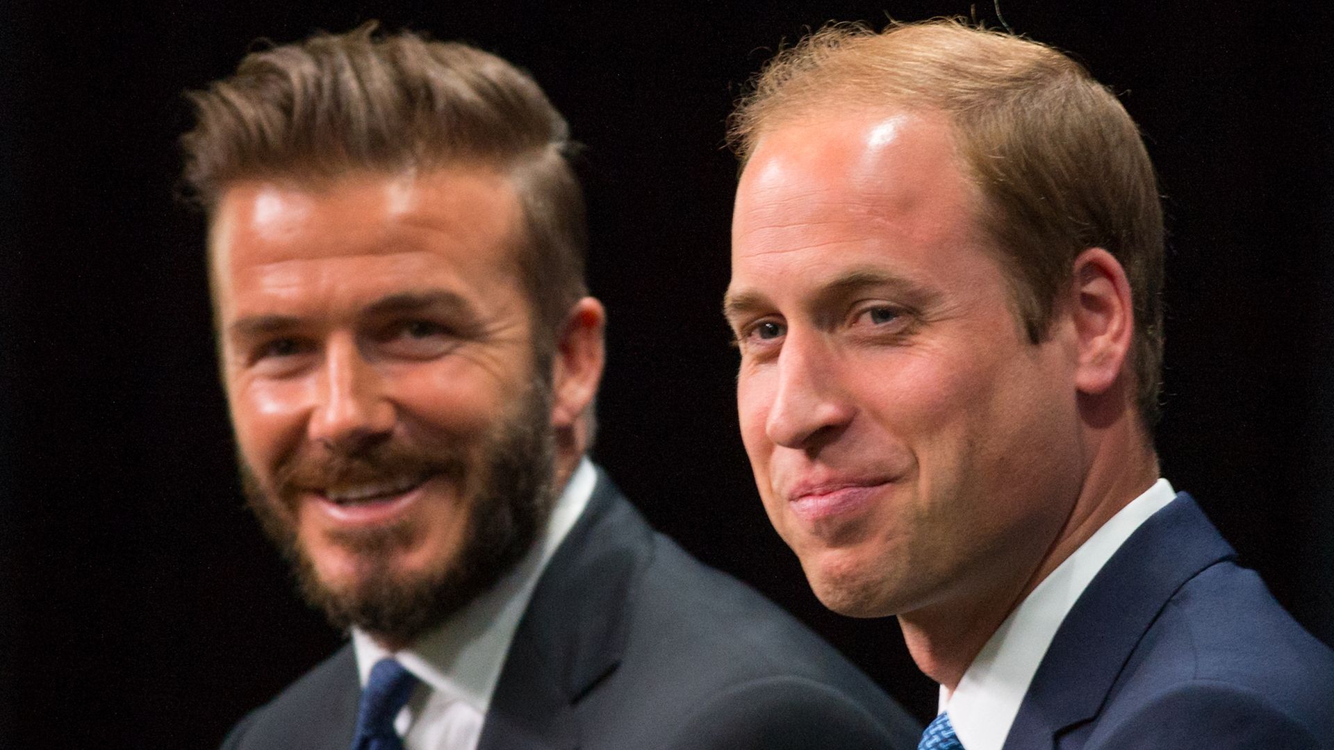 David Beckham and Prince William in front of a black background